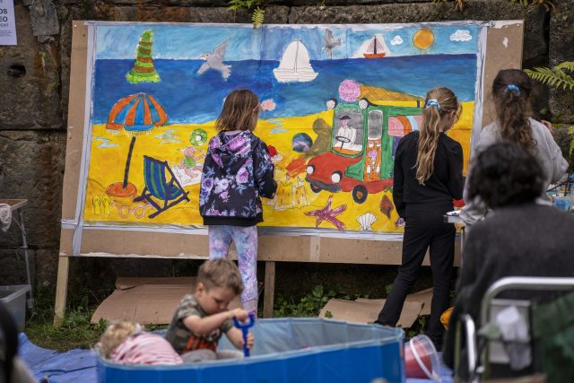 Children painting a beach mural
