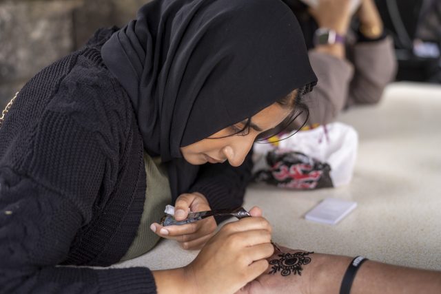 Woman painting Henna on a hand
