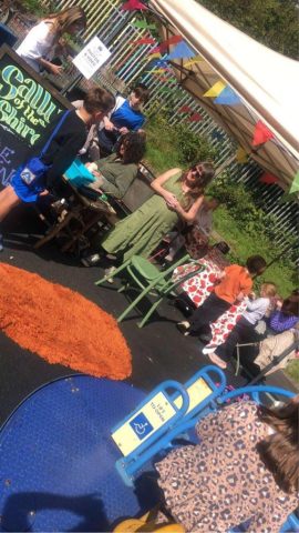 View of face painting work station and participants