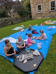 Picture of children making clay seed bombs