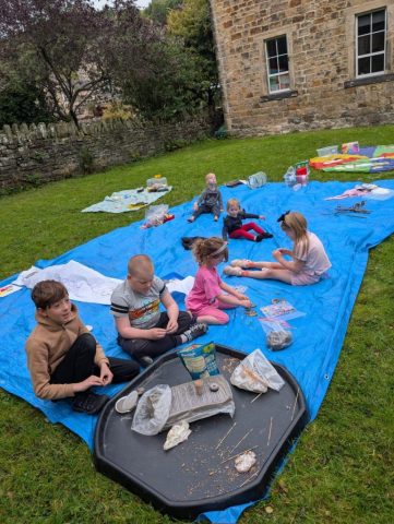 Picture of children making clay seed bombs