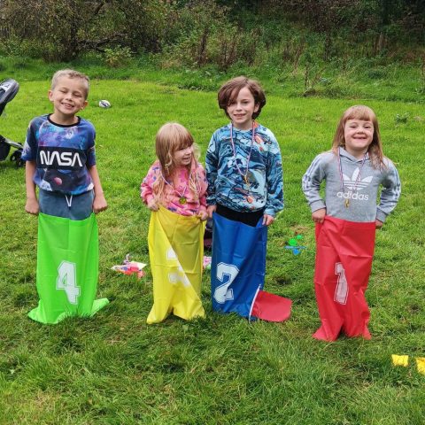 Children in sack race - sports day games